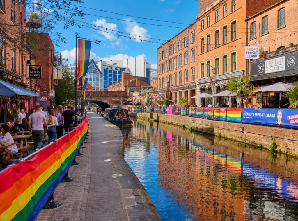 photograph of the rainbow-lined canal path through Manchester’s Gay Village on a sunny afternoon